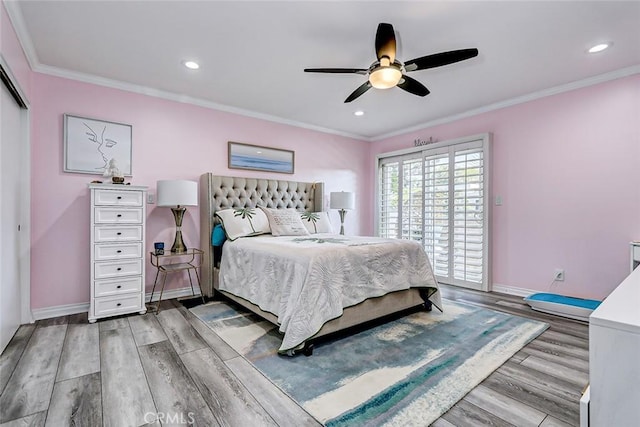 bedroom with ceiling fan, ornamental molding, and light hardwood / wood-style flooring