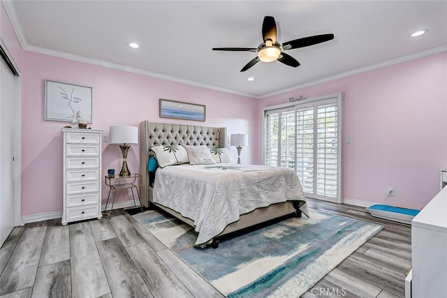 bedroom featuring ornamental molding, wood finished floors, and baseboards