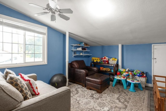 game room featuring vaulted ceiling, ceiling fan, and light hardwood / wood-style flooring