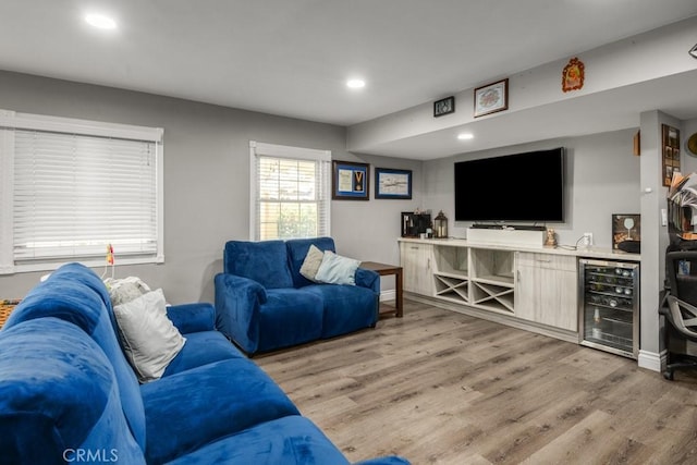 living room with wine cooler and light hardwood / wood-style floors