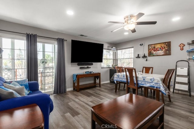 living room with ceiling fan, wood-type flooring, and plenty of natural light