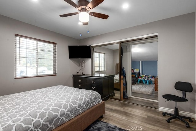 bedroom with hardwood / wood-style flooring, a closet, and ceiling fan