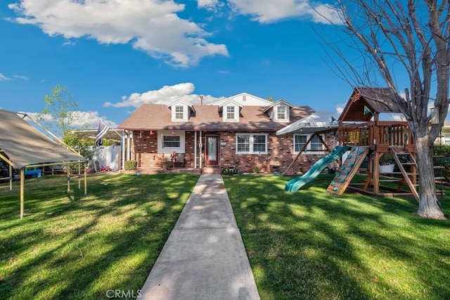 view of front of property featuring a playground and a front yard