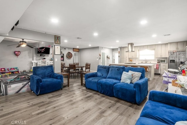 living room featuring sink and light wood-type flooring