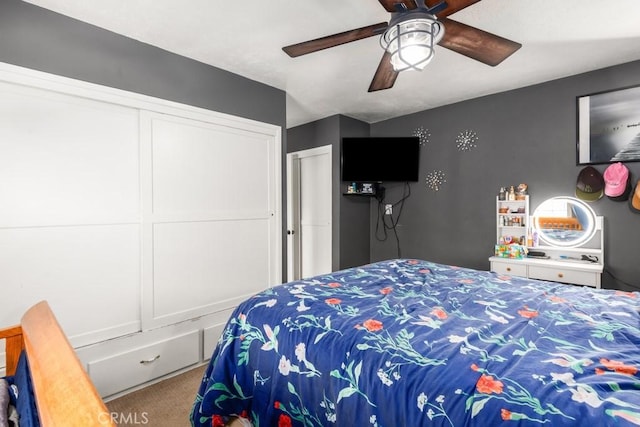 bedroom featuring ceiling fan and carpet