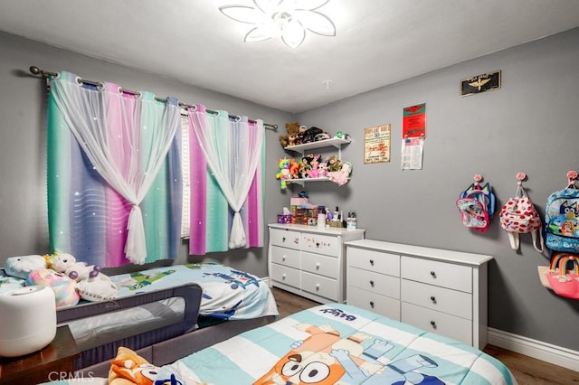 bedroom with dark hardwood / wood-style floors