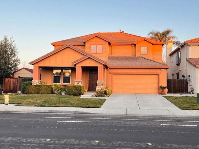 view of front of house with a garage and a yard