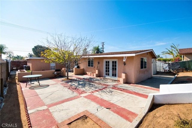 back of property with a patio and french doors