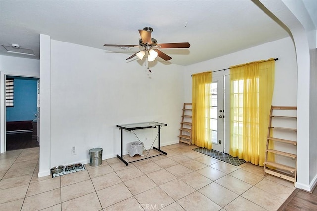 spare room featuring ceiling fan and light tile patterned floors