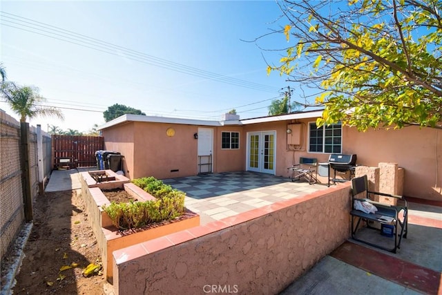 rear view of house with french doors and a patio