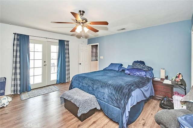 bedroom with hardwood / wood-style floors, access to exterior, ceiling fan, and french doors