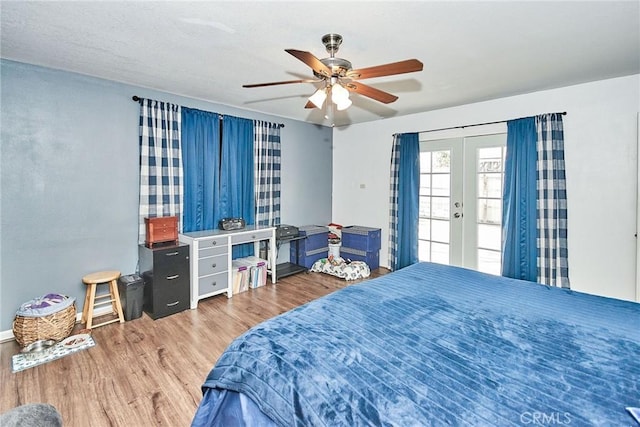 bedroom featuring hardwood / wood-style floors, french doors, ceiling fan, and access to exterior