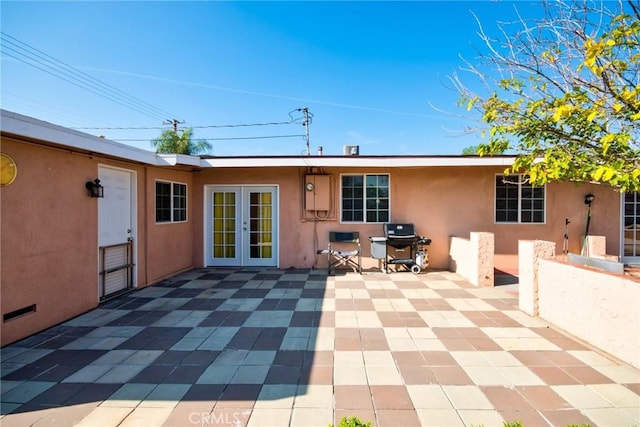 back of house featuring a patio area and french doors