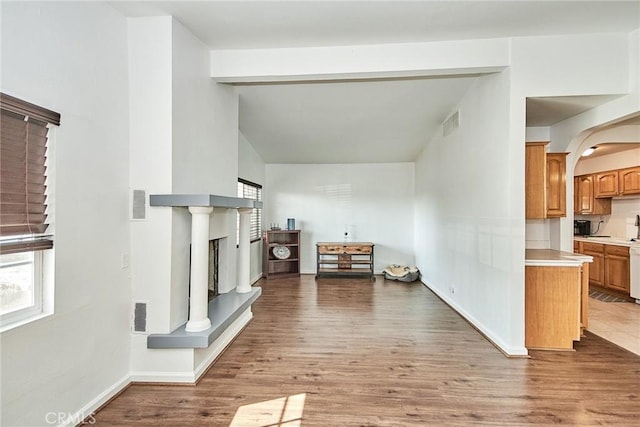 unfurnished living room with lofted ceiling and hardwood / wood-style flooring