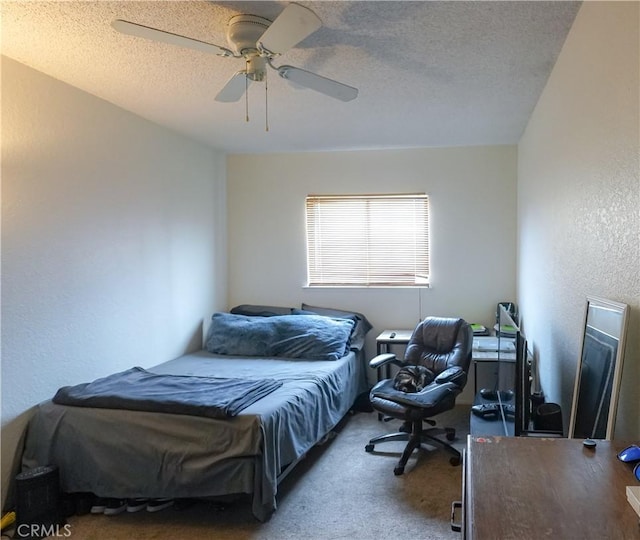 carpeted bedroom with ceiling fan and a textured ceiling