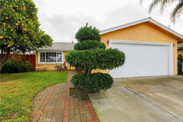 ranch-style home with a garage and a front lawn