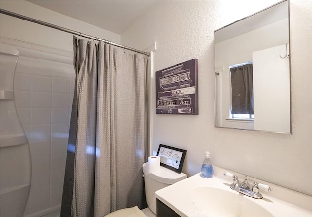 bathroom with vanity, toilet, and curtained shower