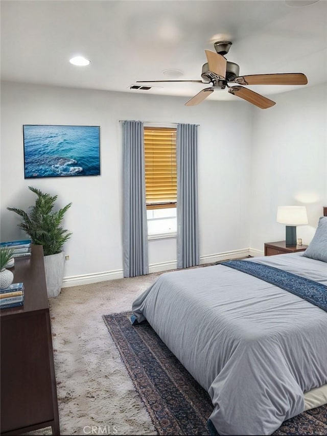 bedroom with a ceiling fan, carpet flooring, visible vents, and baseboards