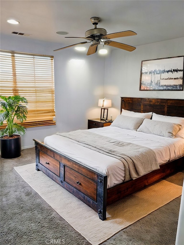 bedroom featuring carpet floors, baseboards, visible vents, and a ceiling fan