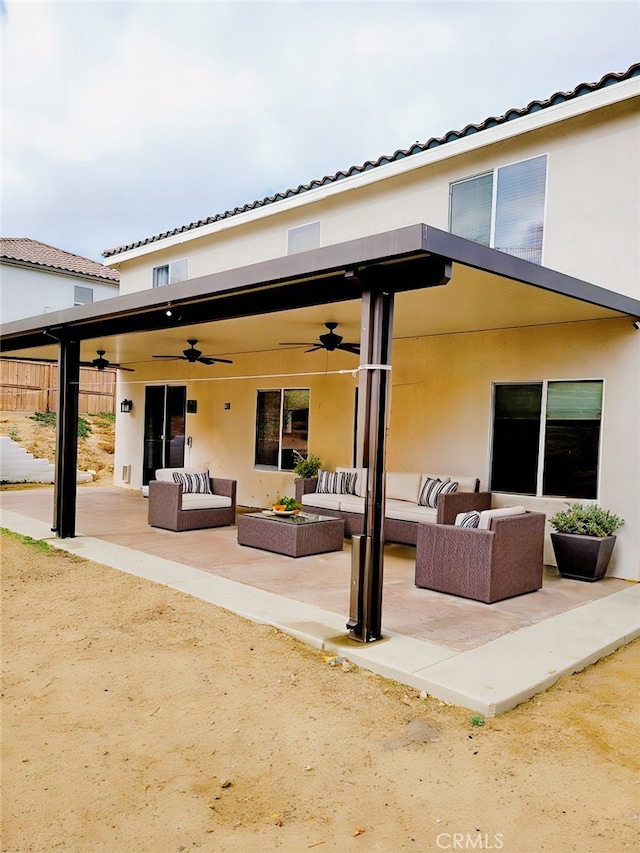 back of property featuring an outdoor living space and stucco siding