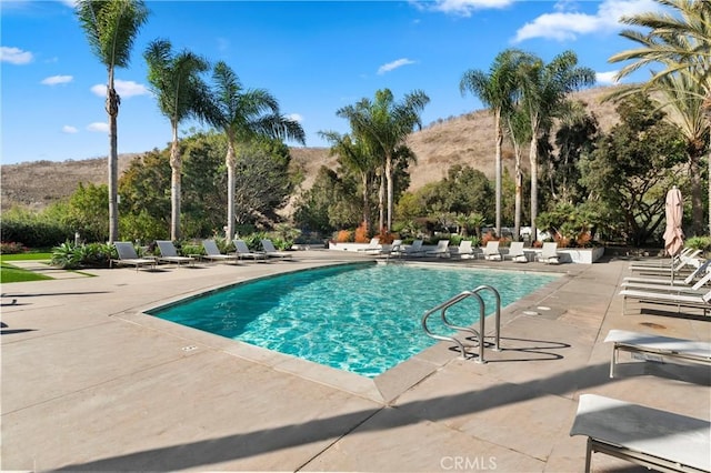 view of swimming pool featuring a mountain view and a patio area