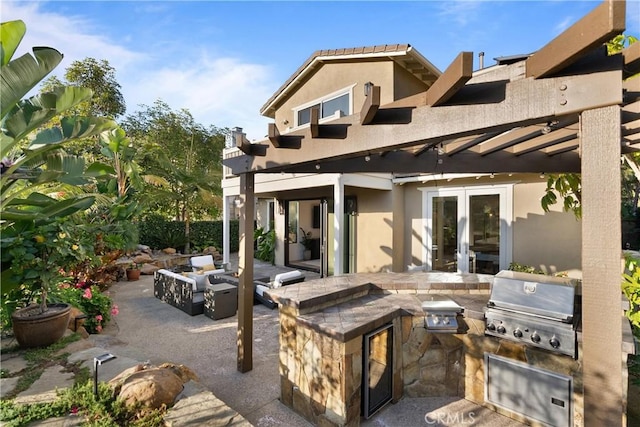 view of patio / terrace with area for grilling, a pergola, an outdoor kitchen, an outdoor living space with a fire pit, and french doors