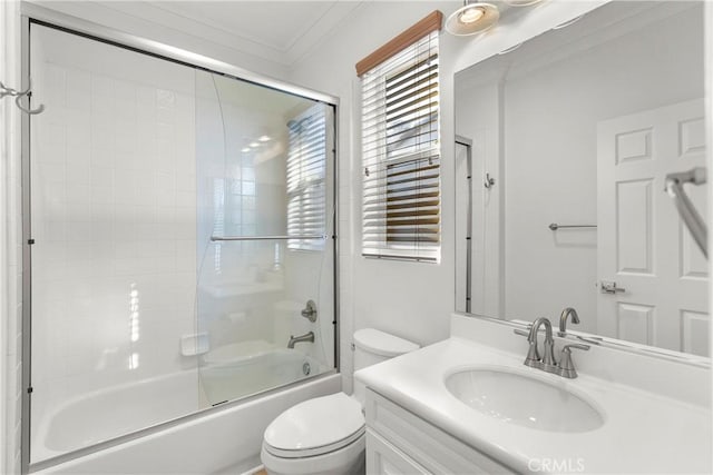 full bathroom with combined bath / shower with glass door, vanity, crown molding, and toilet