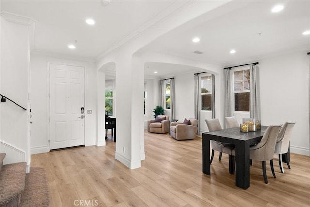 dining room with light hardwood / wood-style flooring and ornamental molding