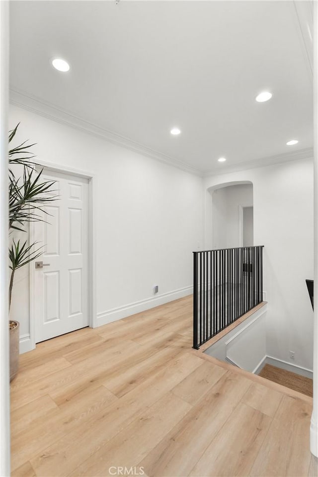 spare room with ornamental molding and wood-type flooring