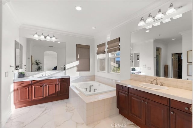 bathroom featuring tiled bath, crown molding, and vanity