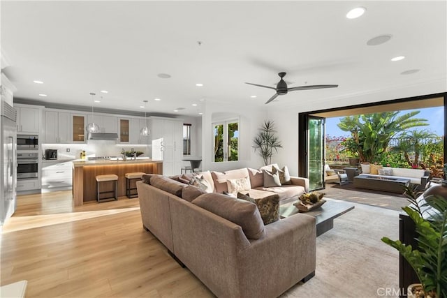 living room featuring light wood-type flooring and ceiling fan