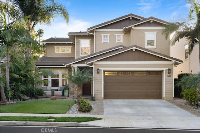 craftsman inspired home featuring a garage and a front yard