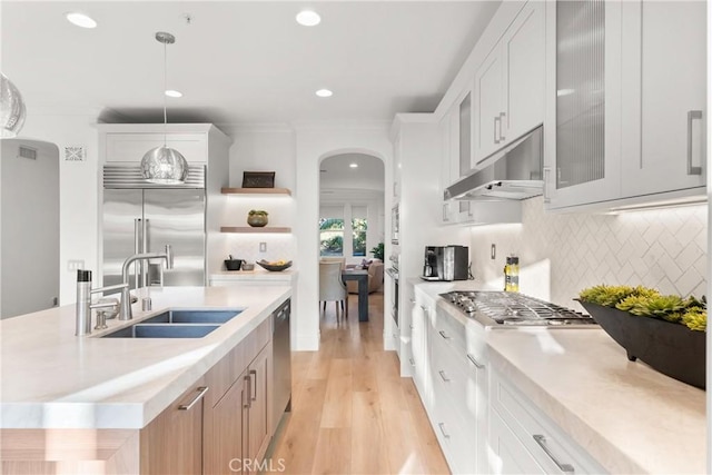 kitchen featuring decorative light fixtures, sink, tasteful backsplash, appliances with stainless steel finishes, and white cabinets