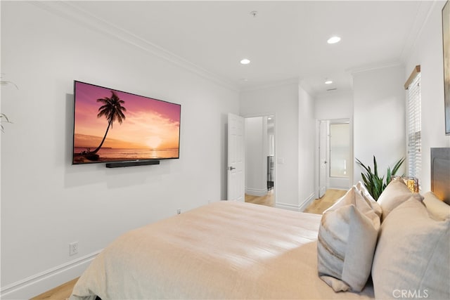 bedroom featuring light hardwood / wood-style floors and crown molding