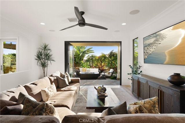 living room featuring ceiling fan and crown molding