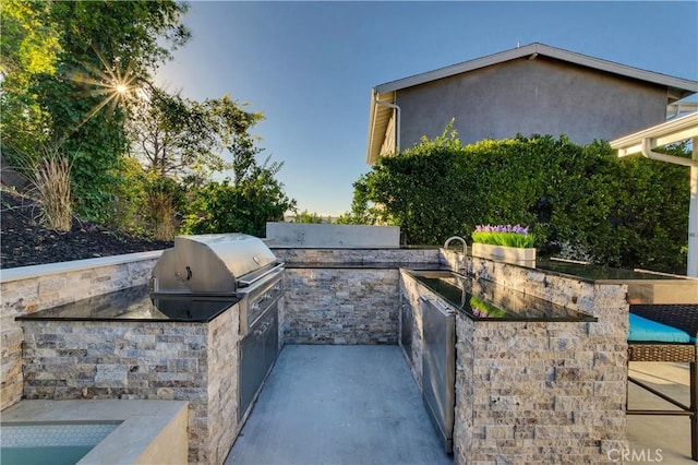 view of patio / terrace with exterior kitchen, a grill, and sink