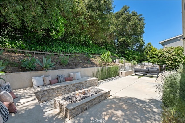 view of patio / terrace with an outdoor fire pit