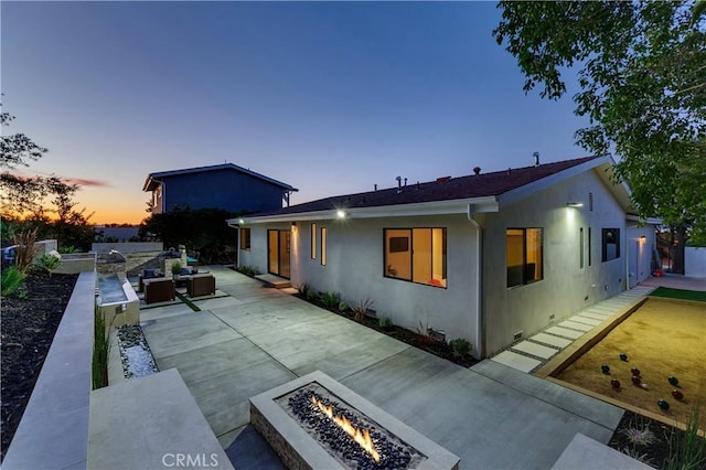 exterior space featuring a patio and a fire pit