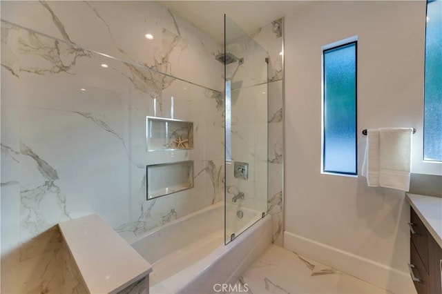 bathroom featuring vanity and tiled shower / bath