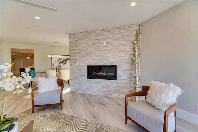 sitting room with hardwood / wood-style flooring and a tile fireplace