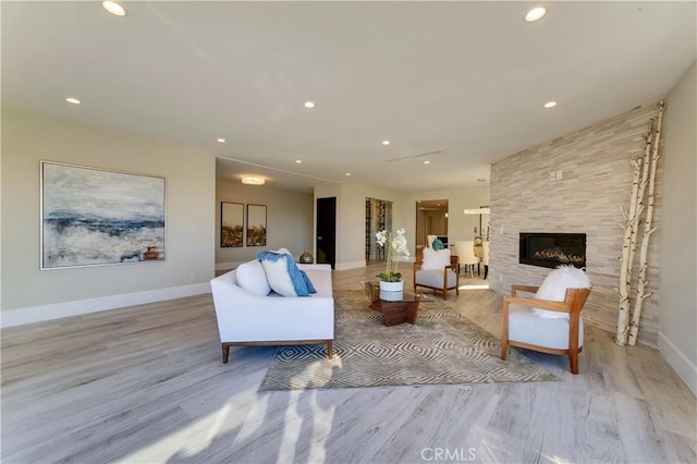 living room featuring a fireplace and light hardwood / wood-style flooring