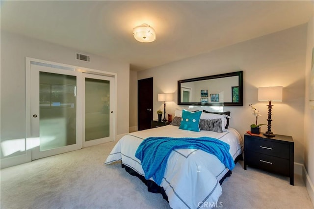 bedroom with light colored carpet