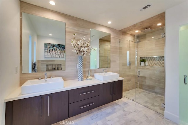 bathroom featuring tile walls, vanity, tasteful backsplash, and walk in shower