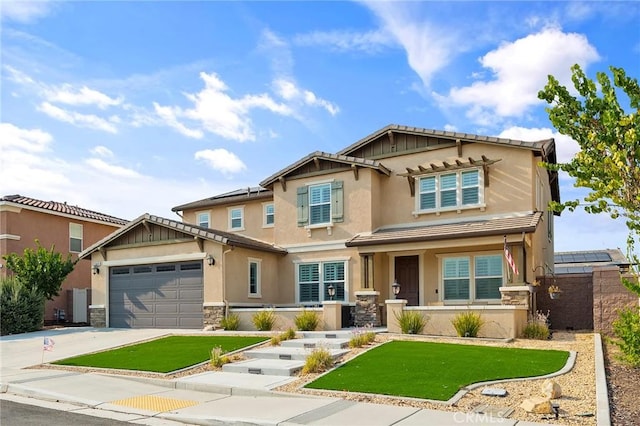 craftsman-style home with a garage, covered porch, and a front yard