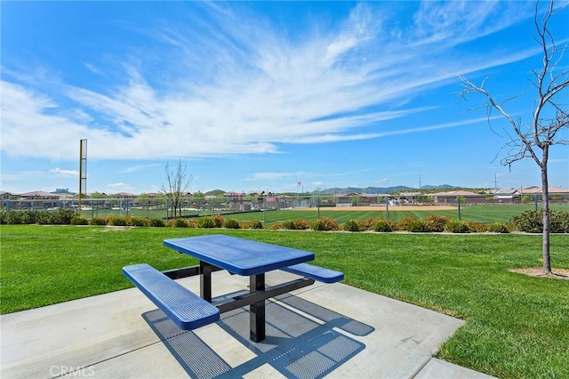 surrounding community featuring a patio area and a lawn