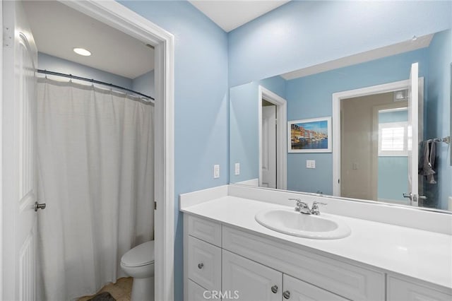 bathroom featuring vanity, toilet, and curtained shower