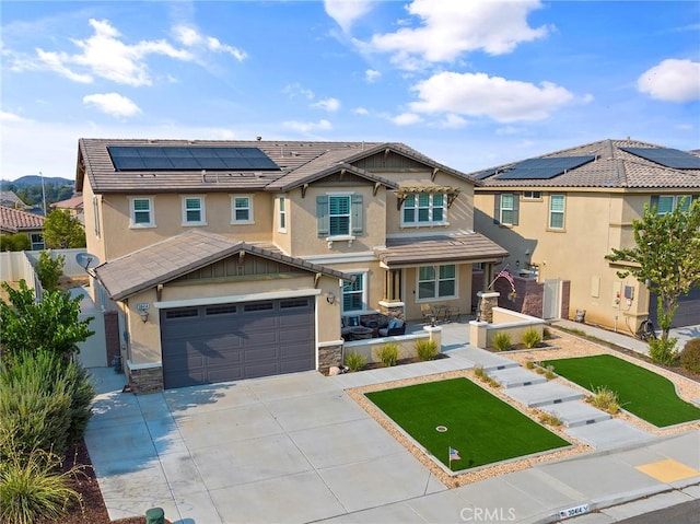 view of front of home featuring a garage and solar panels