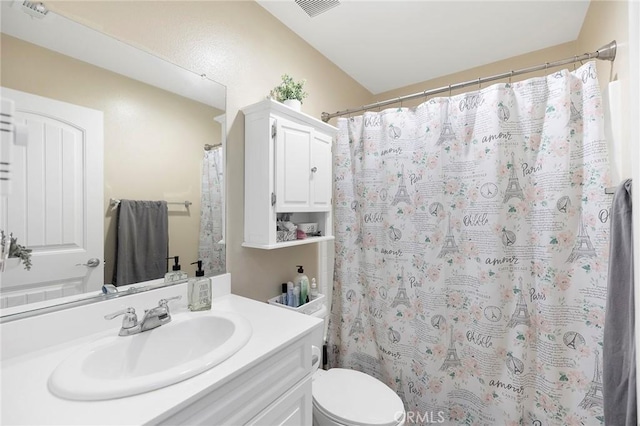 bathroom featuring vanity, toilet, and a shower with shower curtain