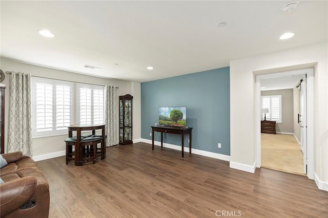 living area with hardwood / wood-style floors and plenty of natural light