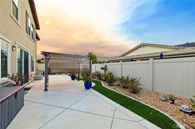 patio terrace at dusk with a pergola